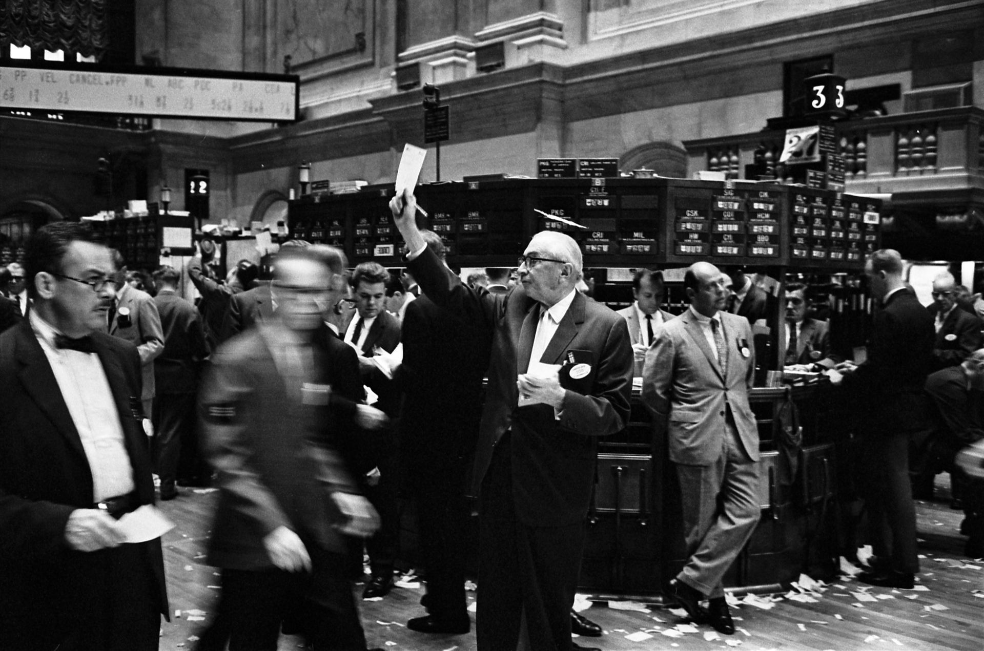 Historic black and white photo of busy traders on the New York Stock Exchange floor